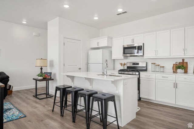 5801 S Garnet Dr Unit 2-301, St George, UT 84790 - kitchen with white cabinets, a center island with sink, appliances with stainless steel finishes, and a sink