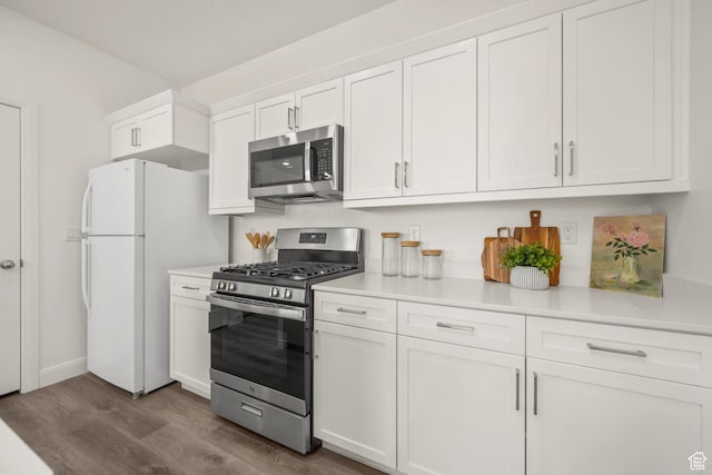 5801 S Garnet Dr Unit 2-301, St George, UT 84790 - kitchen with dark wood finished floors, white cabinets, appliances with stainless steel finishes, and light countertops