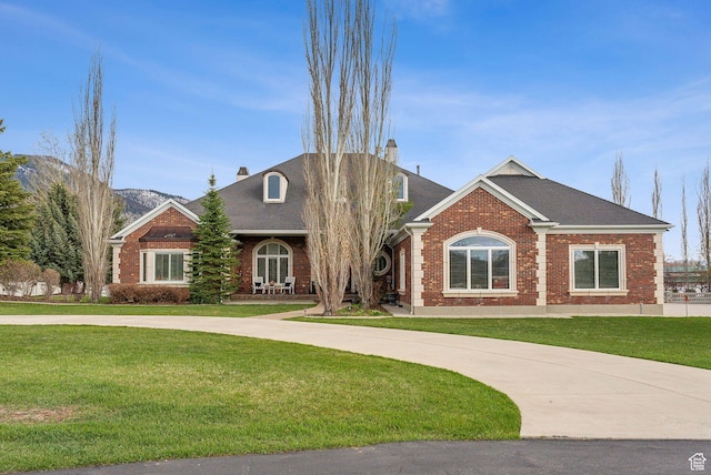 189 E Weber Canyon Rd, Oakley, UT 84055 - view of front facade featuring brick siding, a chimney, and a front yard