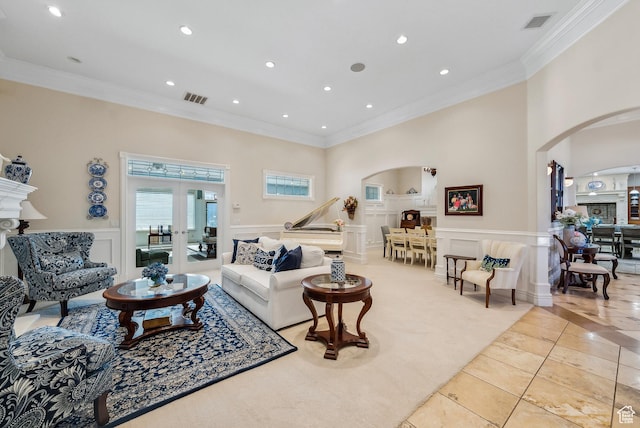 189 E Weber Canyon Rd, Oakley, UT 84055 - living area with visible vents, arched walkways, a decorative wall, and ornamental molding