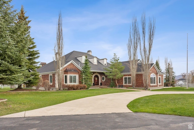 189 E Weber Canyon Rd, Oakley, UT 84055 - view of front of home featuring curved driveway, a chimney, and a front lawn
