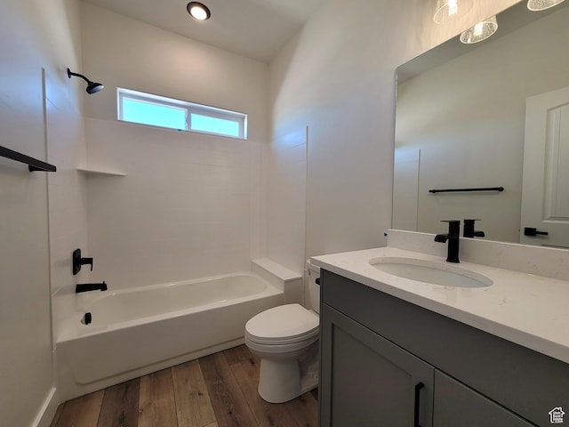 bathroom featuring hardwood / wood-style floors, toilet, shower / bathtub combination, and vanity