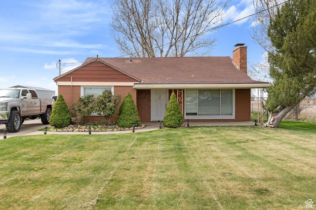 ranch-style home with a chimney and a front lawn