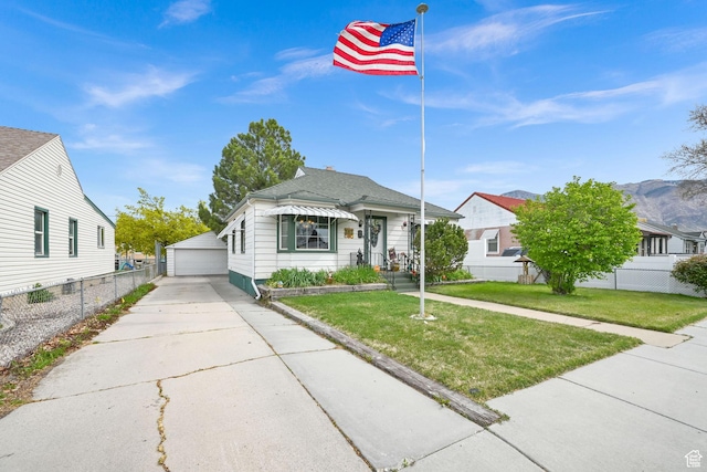 162 Mond St, Ogden, UT 84404 - view of front of house featuring a detached garage, a front lawn, an outdoor structure, and fence