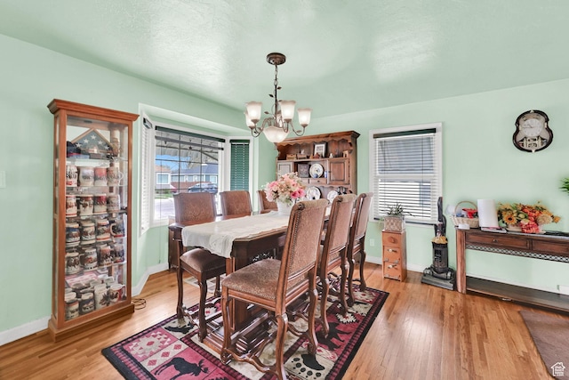 162 Mond St, Ogden, UT 84404 - dining space featuring a chandelier, light wood-style flooring, and baseboards
