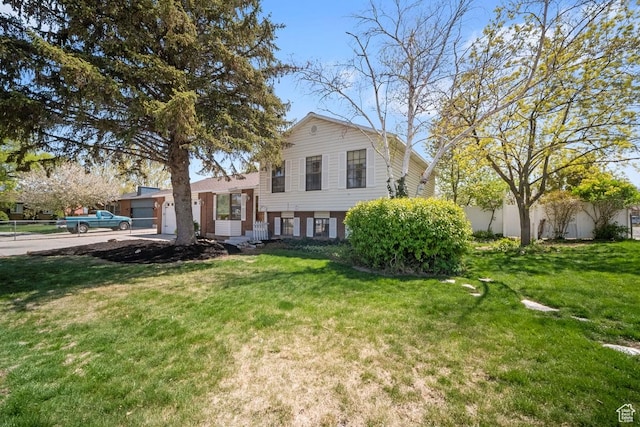 2009 W 7455 S, West Jordan, UT 84084 - tri-level home with an attached garage and a front lawn