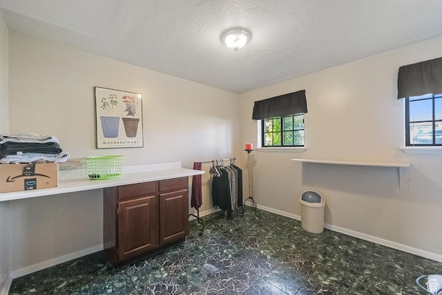 2009 W 7455 S, West Jordan, UT 84084 - laundry room with a textured ceiling, a healthy amount of sunlight, and baseboards