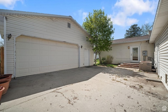 2009 W 7455 S, West Jordan, UT 84084 - view of property exterior with a garage and central AC