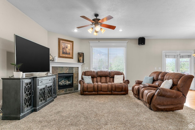 2254 N 1560 W, Pleasant Grove, UT 84062 - carpeted living room featuring a tile fireplace, plenty of natural light, a ceiling fan, and recessed lighting