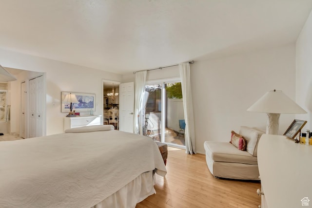 1605 E 6535 S, Murray, UT 84121 - bedroom featuring access to outside, light wood finished floors, a chandelier, baseboards, and ensuite bathroom