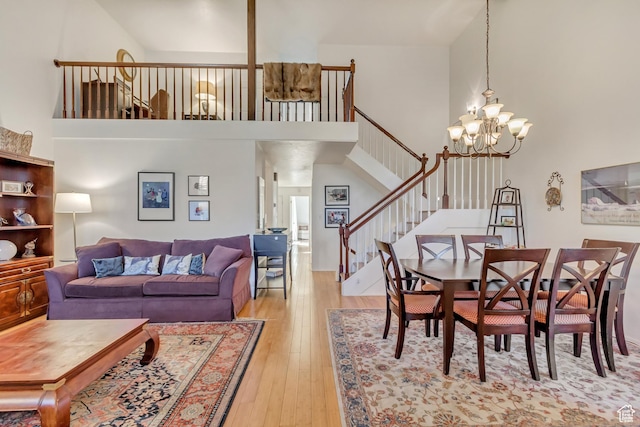 1605 E 6535 S, Murray, UT 84121 - dining room with a chandelier, light wood-style flooring, a high ceiling, and stairs
