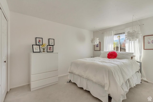 1605 E 6535 S, Murray, UT 84121 - bedroom featuring light carpet, baseboards, and a closet