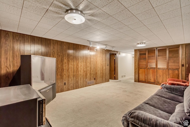 6796 S Nye Dr, Cottonwood Heights, UT 84121 - carpeted living area featuring visible vents, wooden walls, and rail lighting