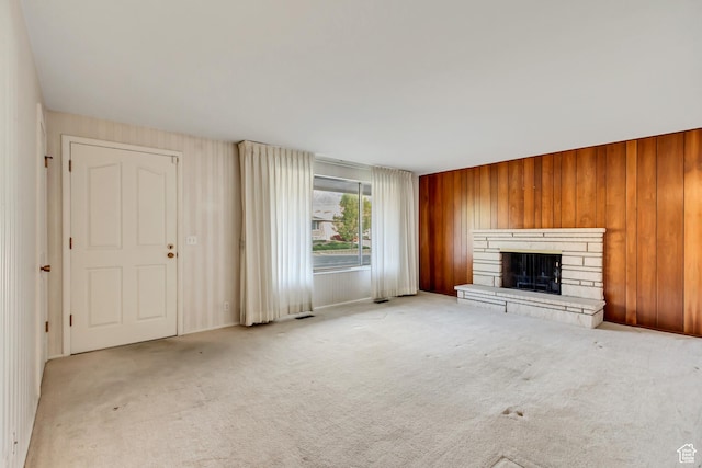 6796 S Nye Dr, Cottonwood Heights, UT 84121 - unfurnished living room featuring wooden walls, visible vents, carpet floors, and a fireplace
