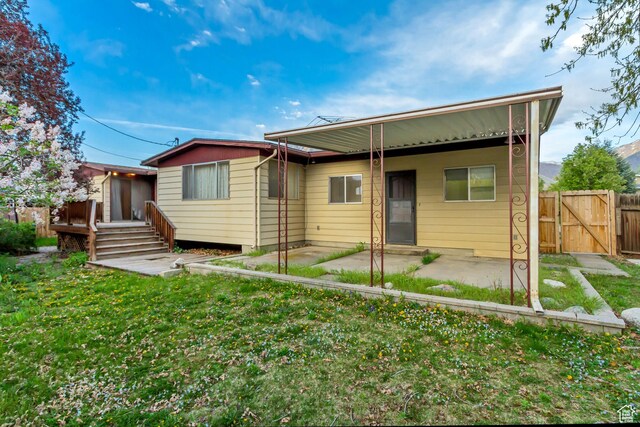 6796 S Nye Dr, Cottonwood Heights, UT 84121 - back of house with a patio, a yard, a gate, and fence