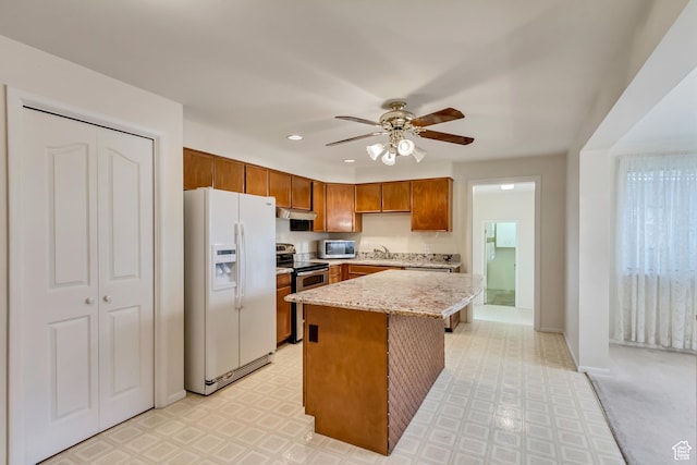 6796 S Nye Dr, Cottonwood Heights, UT 84121 - kitchen with a sink, under cabinet range hood, ceiling fan, appliances with stainless steel finishes, and light floors