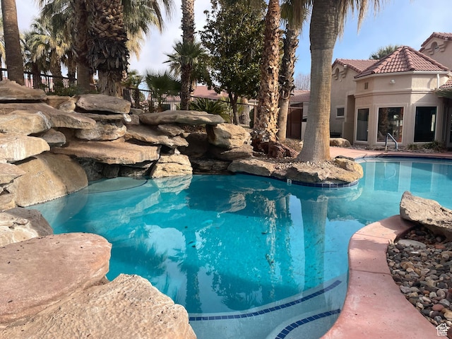 view of swimming pool with fence and a fenced in pool