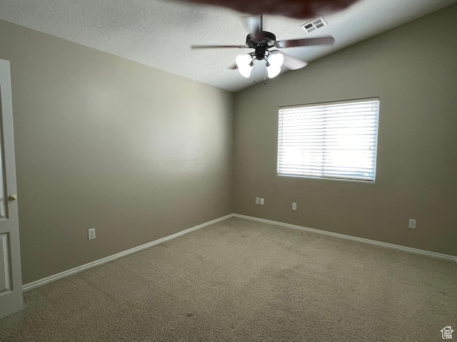 unfurnished room with a textured ceiling, visible vents, baseboards, carpet floors, and a ceiling fan