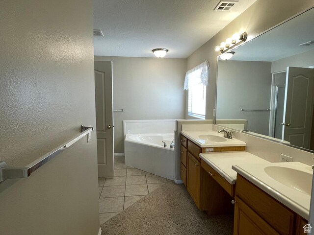 full bath with visible vents, vanity, a garden tub, and tile patterned flooring