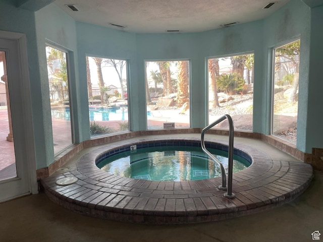 view of pool with an indoor in ground hot tub
