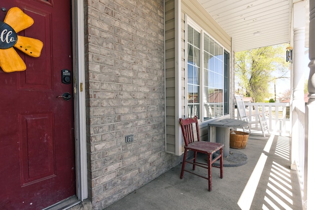 26 Orchard Ln S, Grantsville, UT 84029 - view of exterior entry featuring a porch and brick siding