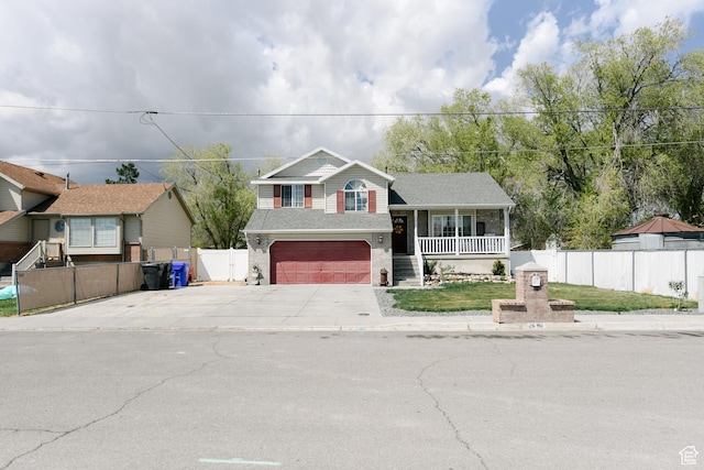 26 Orchard Ln S, Grantsville, UT 84029 - tri-level home with a porch, driveway, a garage, brick siding, and fence