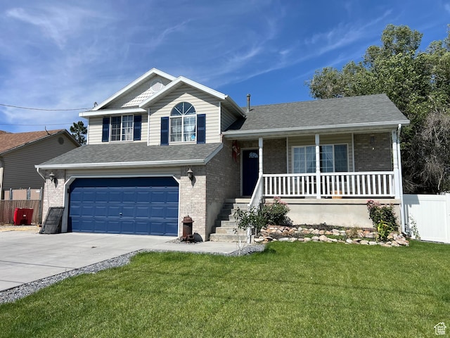 26 Orchard Ln S, Grantsville, UT 84029 - tri-level home featuring brick siding, concrete driveway, a garage, covered porch, and roof with shingles