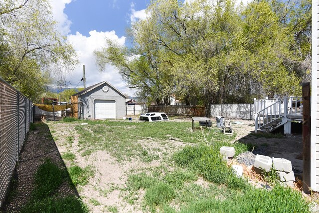 26 Orchard Ln S, Grantsville, UT 84029 - view of yard featuring a fenced backyard, a deck, and stairway