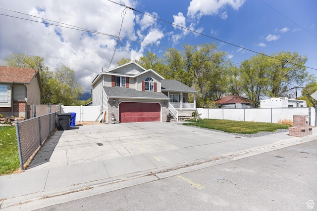 26 Orchard Ln S, Grantsville, UT 84029 - split level home with fence, covered porch, brick siding, concrete driveway, and an attached garage