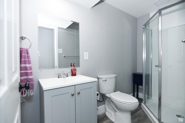 26 Orchard Ln S, Grantsville, UT 84029 - bathroom featuring vanity, toilet, wood finished floors, and a stall shower