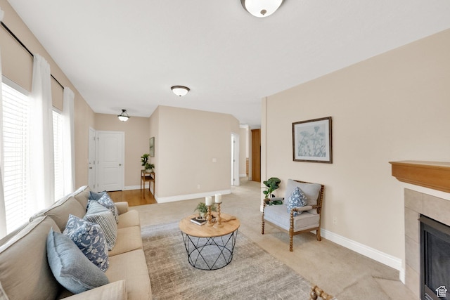 6872 S Triumph Ln, West Jordan, UT 84088 - living room featuring light carpet, a fireplace, and baseboards