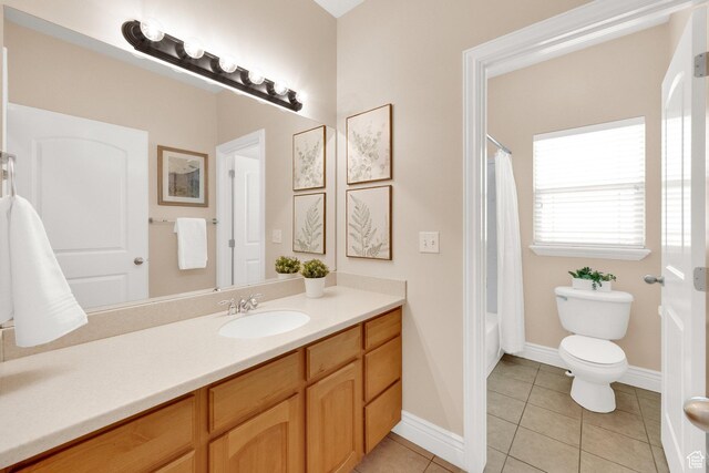 6872 S Triumph Ln, West Jordan, UT 84088 - bathroom featuring vanity, tile patterned flooring, toilet, baseboards, and shower / bath combo