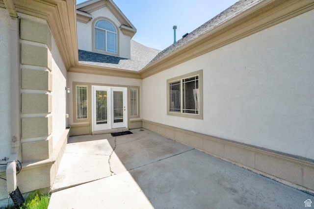 6872 S Triumph Ln, West Jordan, UT 84088 - property entrance with a shingled roof, a patio, and stucco siding