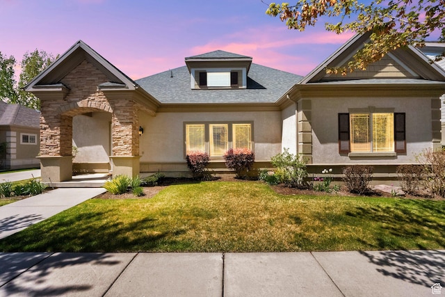 6872 S Triumph Ln, West Jordan, UT 84088 - view of front of house featuring a front lawn, stucco siding, and stone siding