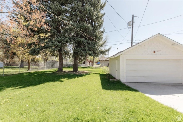 view of yard featuring a garage and fence