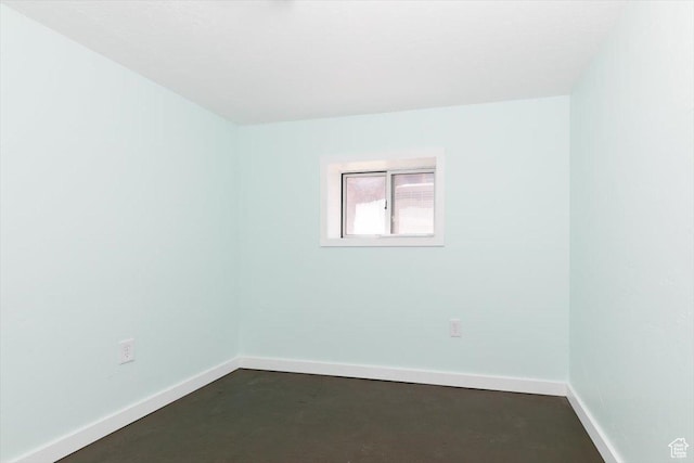 empty room featuring baseboards