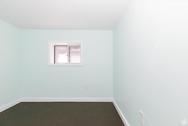 spare room featuring baseboards