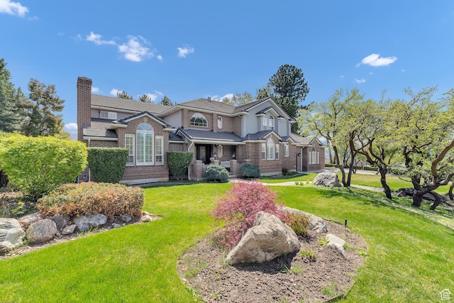 773 Northridge Ct, Farmington, UT 84025 - view of front facade with a front lawn, a chimney, and brick siding