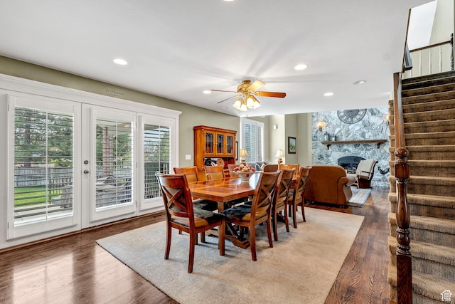 773 Northridge Ct, Farmington, UT 84025 - dining room featuring a fireplace, stairway, wood finished floors, and recessed lighting