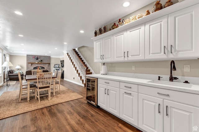 773 Northridge Ct, Farmington, UT 84025 - kitchen featuring a sink, baseboards, white cabinets, open floor plan, and beverage cooler