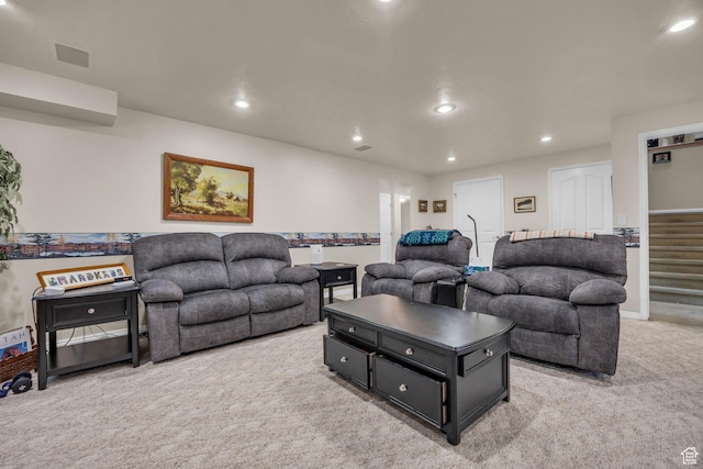 living room featuring light carpet, recessed lighting, baseboards, and stairway