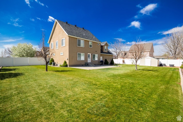 103 E 1150 S, Roosevelt, UT 84066 - rear view of house featuring an outdoor structure, a fenced backyard, a yard, a storage shed, and a patio area