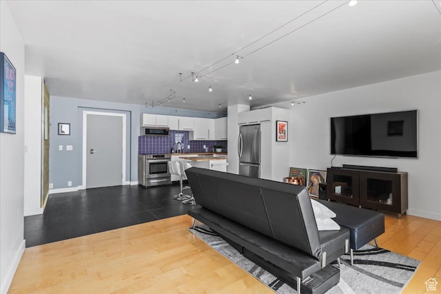 875 S Donner Way Unit 1208, Salt Lake City, UT 84108 - living room featuring dark wood-style flooring and baseboards