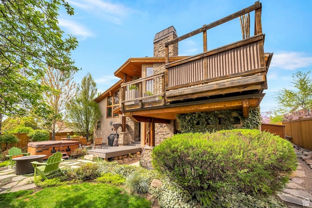 3200 E 3900 S, Salt Lake City, UT 84124 - back of property featuring fence, a wooden deck, a hot tub, and stone siding