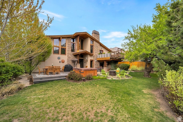 3200 E 3900 S, Salt Lake City, UT 84124 - rear view of property featuring a yard, a hot tub, a chimney, a deck, and stucco siding
