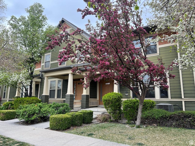 view of front of home with covered porch and central AC