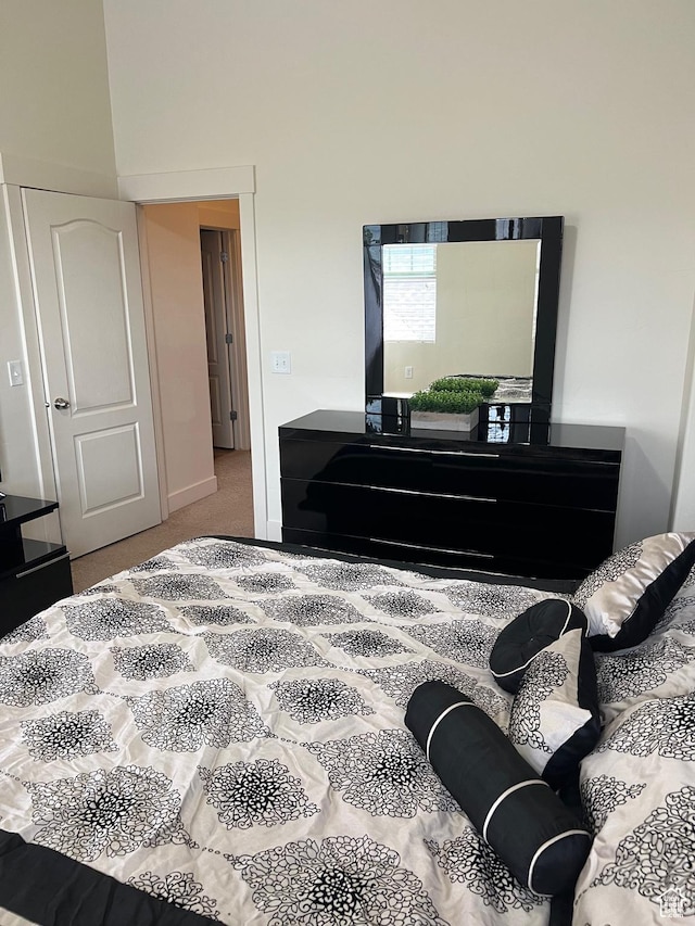 bedroom featuring carpet flooring and a high ceiling