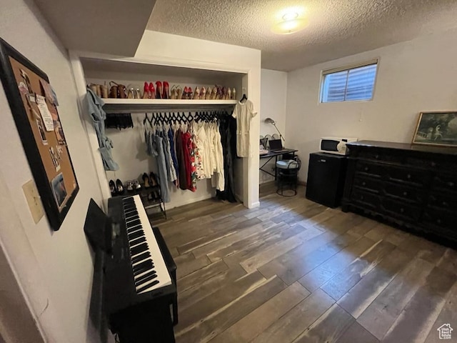 397 W 4125 N, Pleasant View, UT 84414 - bedroom with a textured ceiling, dark wood-style floors, and a closet