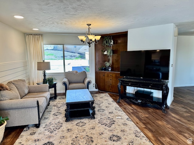 397 W 4125 N, Pleasant View, UT 84414 - living room with a textured ceiling, wood finished floors, and a chandelier