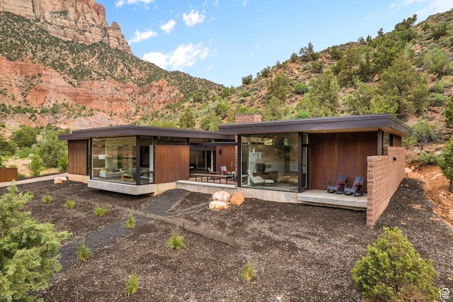 112 Canyon Cv, Springdale, UT 84767 - rear view of house featuring a chimney and a deck with mountain view